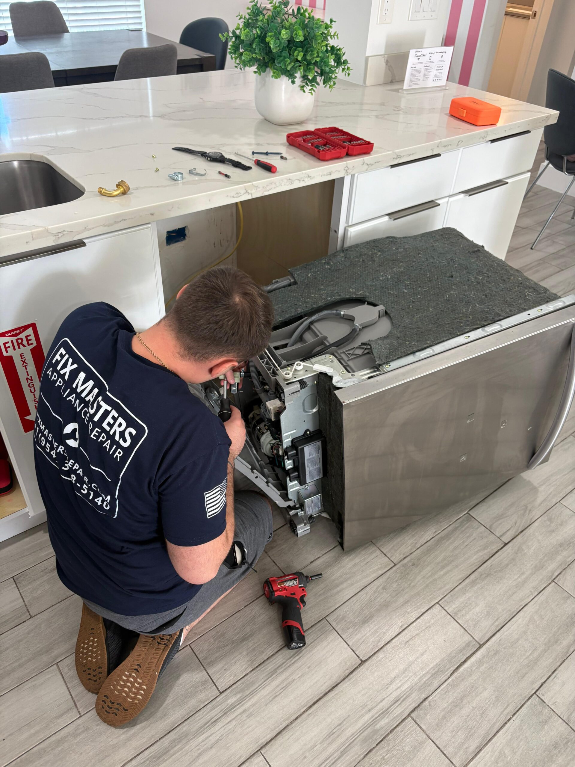 Fix Masters technician repairing dishwasher in Miami kitchen